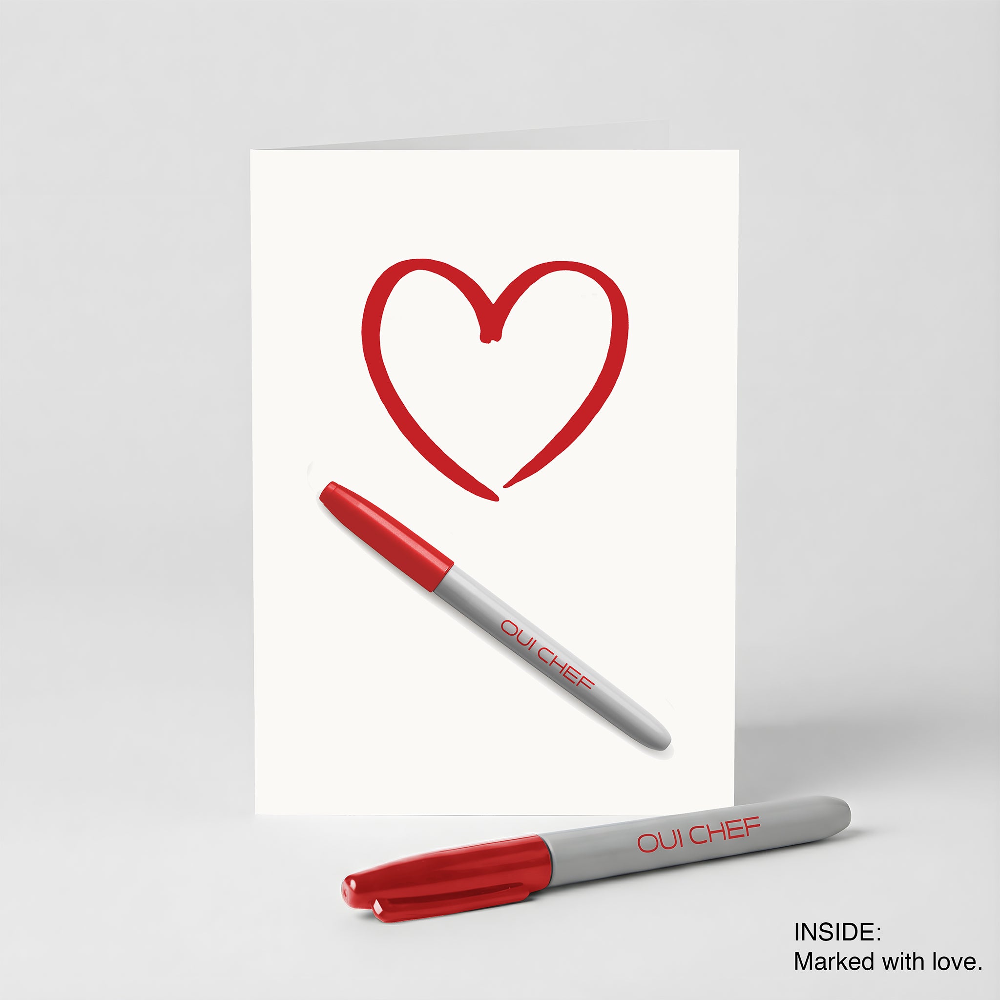 Valentines card with A red heart drawn on the front and a red Sharpie on a white background.