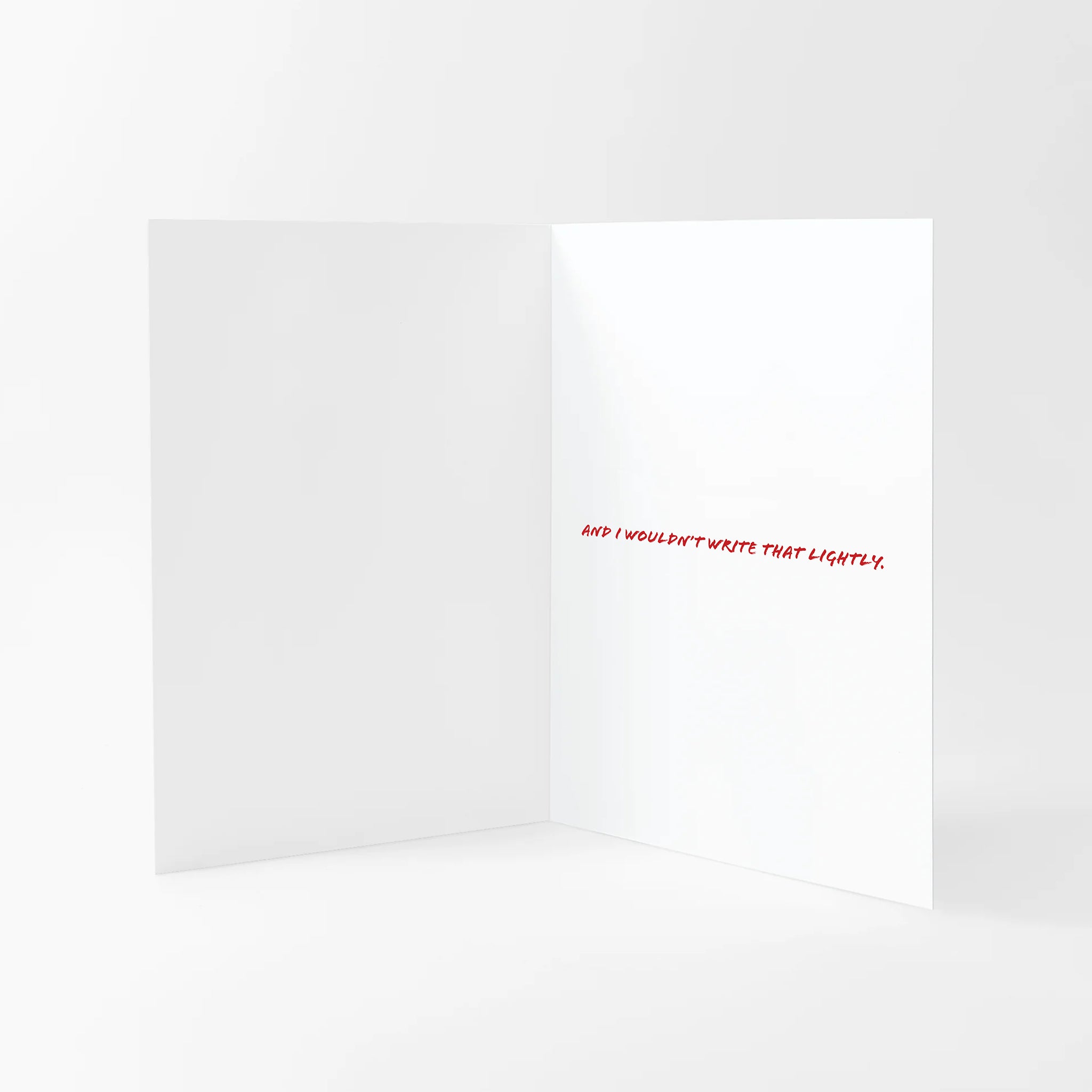 Valentines card with 'And I wouldn't write that lightly' text on the inside against a white background.