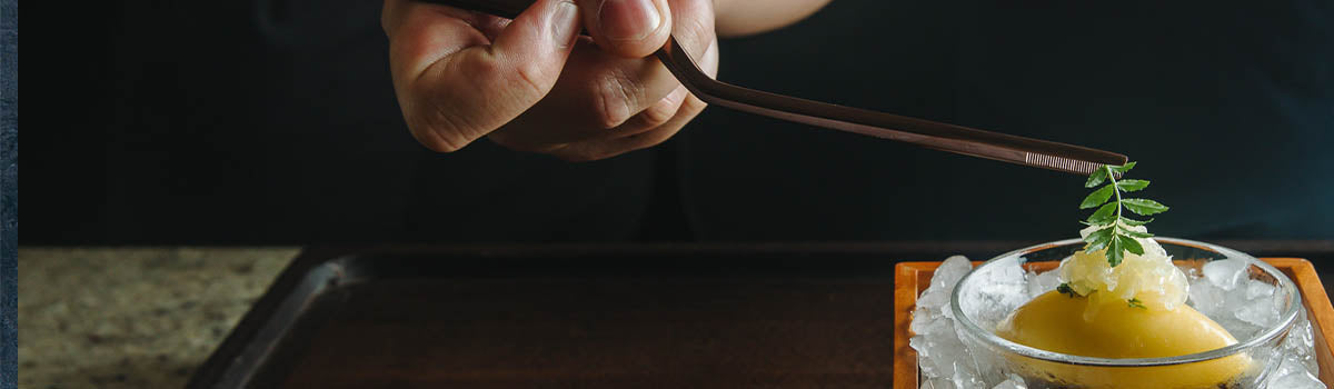 Chef expertly garnishing with Oui Chef offset tweezers