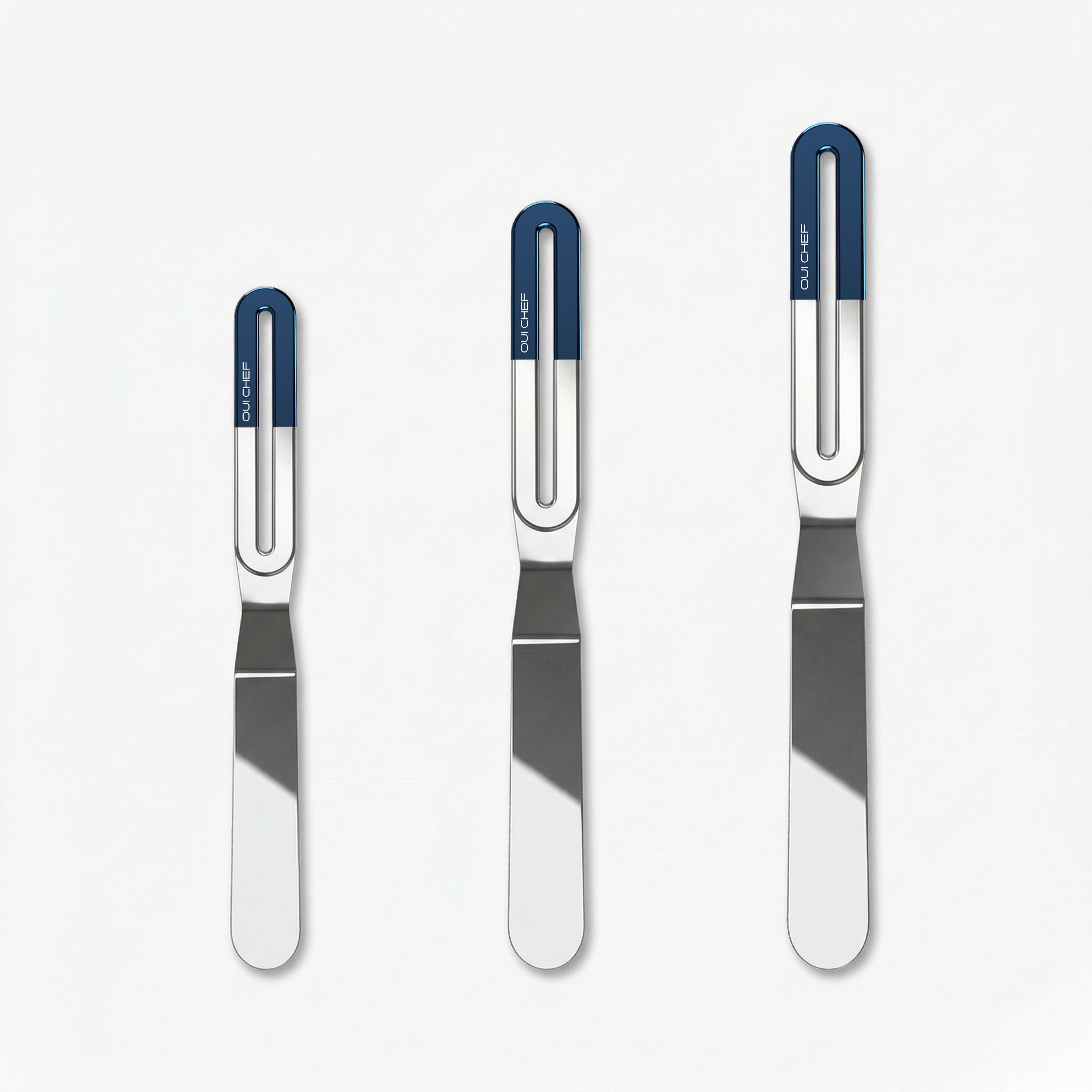 Three stainless steel offset palette knives of increasing size, each with a sleek metal blade and a blue ergonomic handle labeled “OUICHEF,” arranged side by side on a light background.
