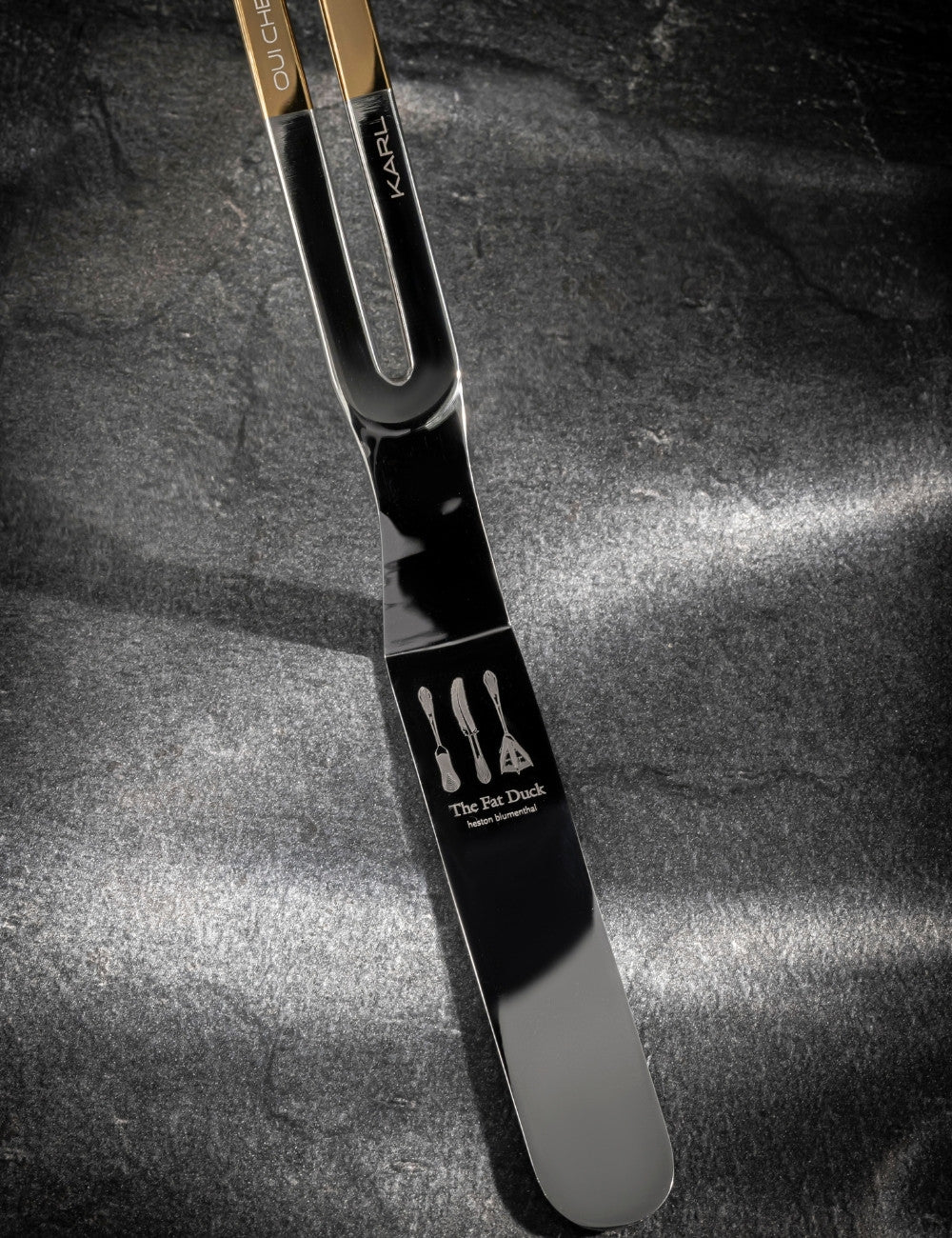 Stainless steel gold top palette knife with "The Fat Duck" restaurant logo engraved on the base and "Karl" engraved on the handle.