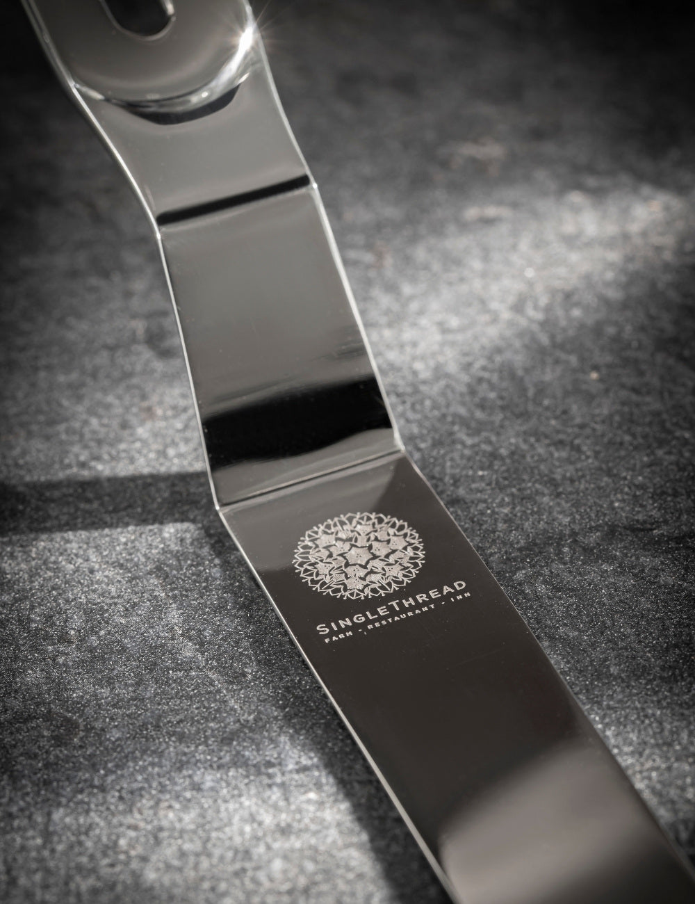 Stainless steel palette knife with "SingleThread Farm" restaurant logo engraved.