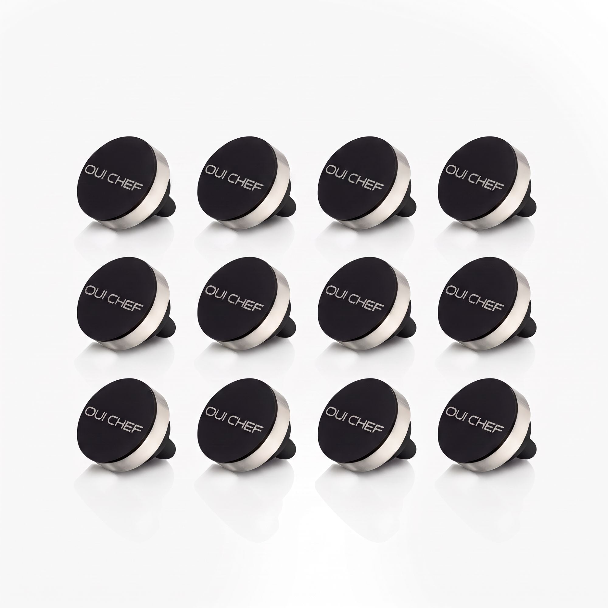 Oui Chef HoldFast Magnetic Chef's Pin 12 Pack with four black magnetic pins for chef jackets and aprons on a white background