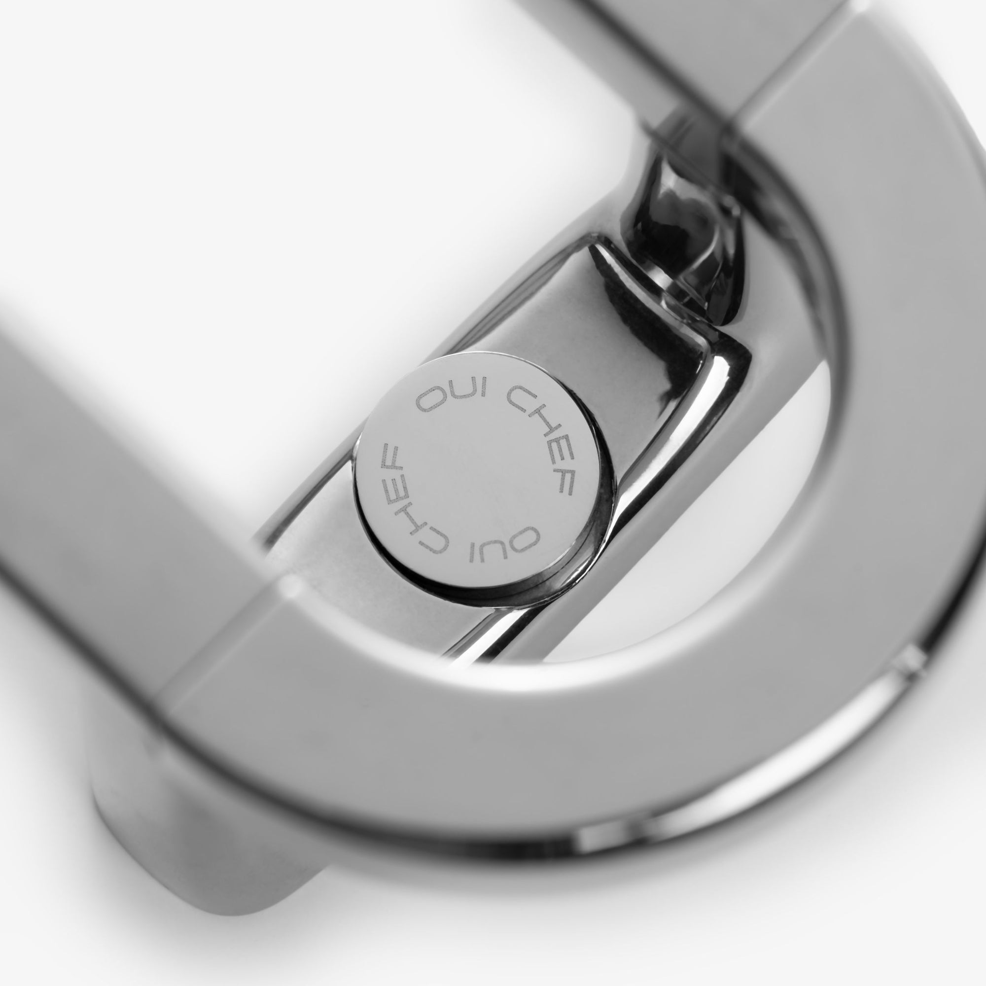 A close up image of the brackets on the ShowOff stainless steel magnetic rack which shows the "Oui Chef" logo engraved on the top and bottom of clip that covers the screw.